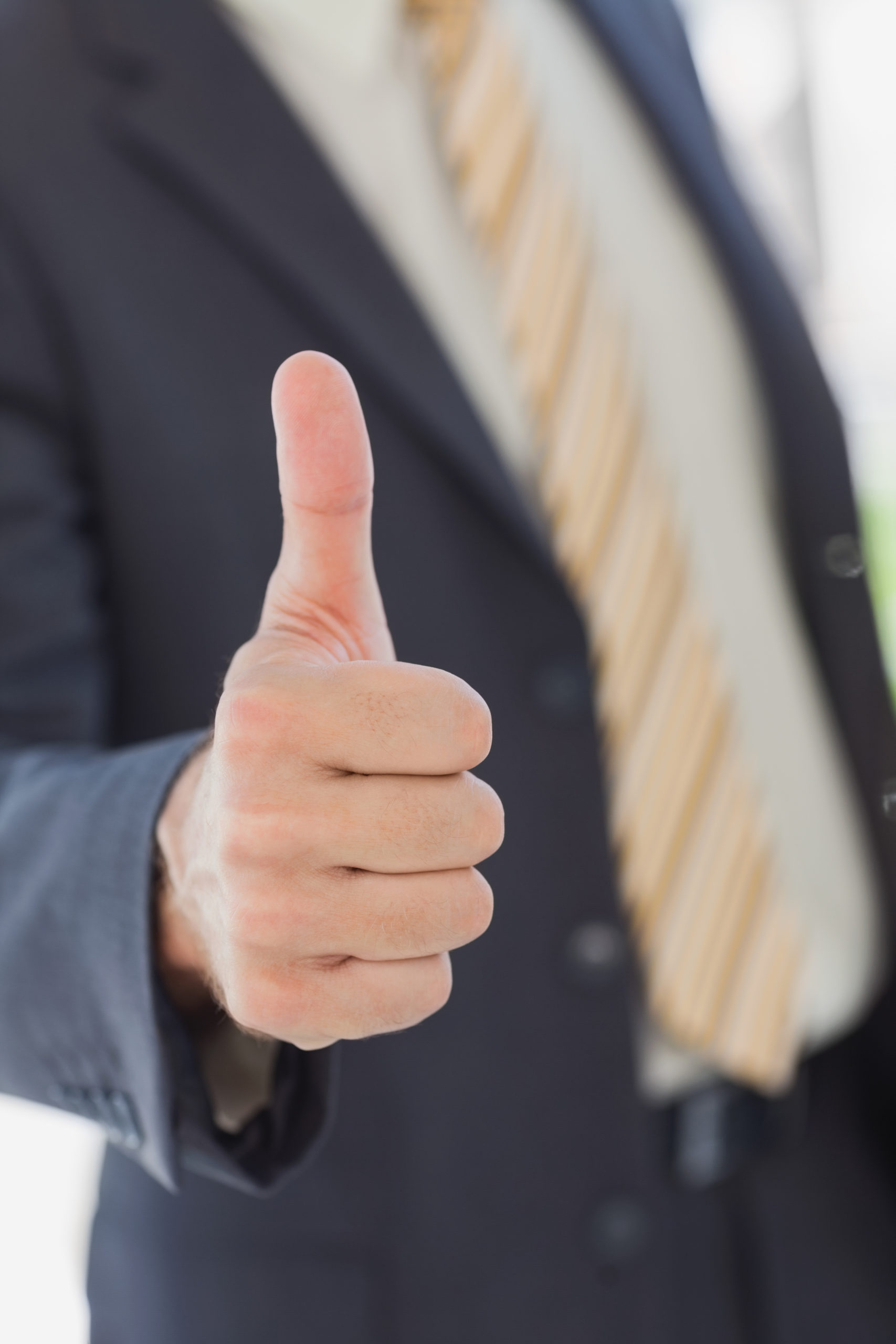 Businessman,Showing,Thumbs,Up,In,Office